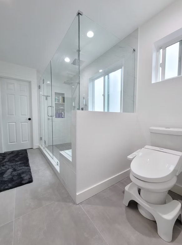 Walk-in shower with frameless glass and modern fixtures, installed for a Kirkland homeowner